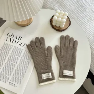 Knitted gloves detail, solid brown winter warm gloves with ribbed cuffs and tag.