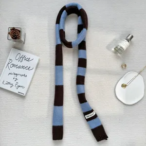 Blue brown striped knit narrow scarf detail view, showing the soft texture and color design.