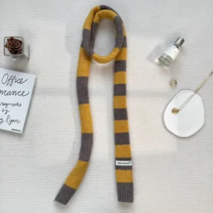Detailed view of a trendy Y2K colorblock striped knitted long narrow scarf for women.