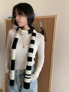 Black and white striped knitted narrow scarf Y2K style fashion accessory knitwear detail