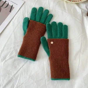 Detailed close-up of color-block knit gloves in green and brown, cozy winter warm texture.