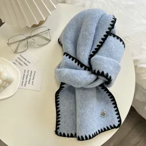 Cozy light blue winter knitted scarf featuring black zigzag edges and sweet heart charm.