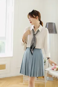 Detailed shot of elegant outfit featuring a chic narrow plaid neck scarf, stylish and refined.