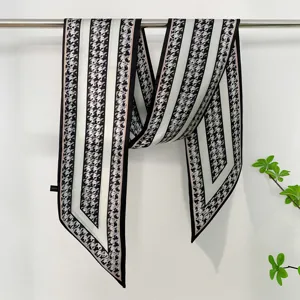 Detailed view of the chic black and white houndstooth twilly scarf, elegant ribbon design for bags.