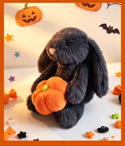 Detailed view of the cute black plush rabbit holding a mini pumpkin, Halloween themed decor.