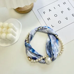 Detailed view of the blue floral silk scarf necklace with pearl pendant and magnetic clasp.