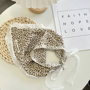 Leopard print bandana detail, white lace trim and tie strings for sweet French style hair accessory.