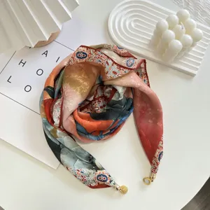 Detail view of stylish lightweight floral scarf with elegant magnetic buckle closure for spring.