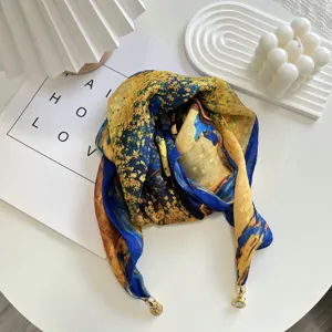 Close-up detail of artistic print square scarf with magnetic metal clasp, elegant style.