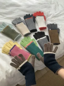 Knit touchscreen gloves detail showing long color-blocked cuffs and cozy winter warmth.