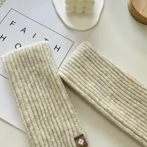 Detailed view of soft ribbed knit arm sleeves, cozy winter warm knitwear accessory close up.