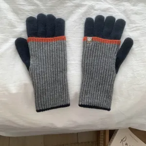 Knit touchscreen gloves in grey and black with orange stripe detail for winter warmth.
