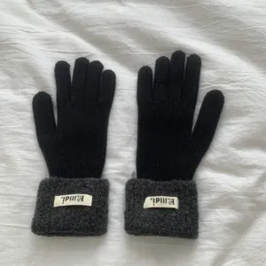 Solid color knitted winter gloves for women with thick plush cuffs, warm and elastic daily wear.