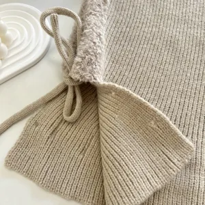 Close up detail of womens winter knitted balaclava hood with plush lining and drawstring.