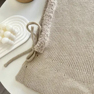 Cozy beige knit balaclava hood with plush trim and drawstrings for winter warmth.