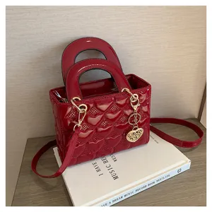 Red patent leather quilted handbag with heart pattern, elegant shoulder crossbody bag for women.