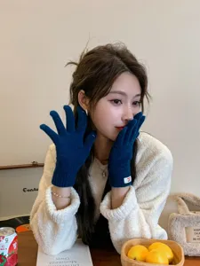 Cozy winter knitted five-finger gloves in deep blue, soft warm fabric for cold weather style.