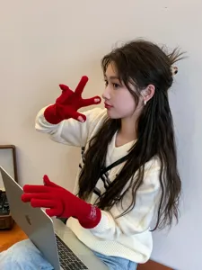 Detail view of women's red knitted long fingerless gloves, cute winter warm cozy hand wear.