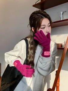 Stylish women's winter knit long gloves in bright magenta, warm five-finger design for cold days.