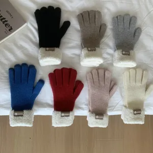 Close up detail shot of thick cozy winter knit gloves featuring soft plush cuffs and multi-color options.