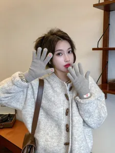 Cozy winter knit fingerless gloves for women, warm soft wool material in elegant grey.