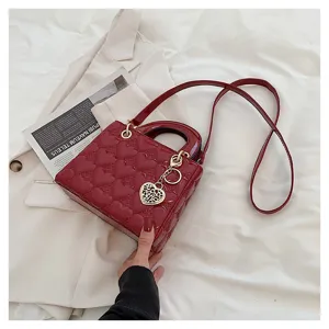 Red patent leather heart quilted handbag, chic top handle crossbody bag for women.