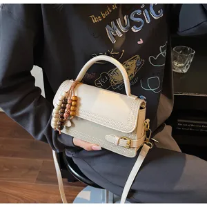 Chic cream white top-handle shoulder bag for women, elegant PU leather crossbody handbag.
