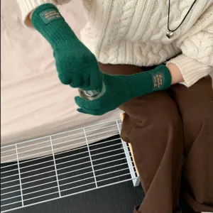 Green knitted long gloves for women, warm winter five-finger gloves with stylish cuff label design.