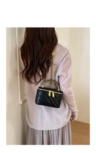 Quilted chain vanity bag with gold handle, elegant shoulder crossbody bag for women.