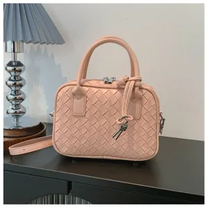 Pink woven leather detail view, featuring classic intrecciato style and delicate metal zippers.