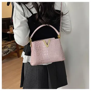 Pink crocodile pattern shoulder bag for women, stylish handbag with gold V metal clasp.
