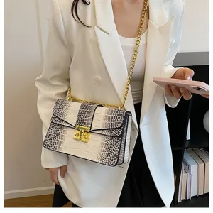 Chic crocodile pattern shoulder bag for women, featuring a stylish lock and gold chain strap.