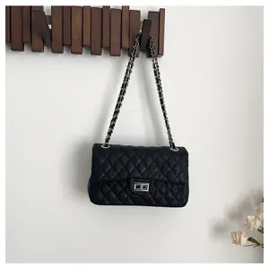Classic black quilted shoulder bag with silver chain strap and chic turn-lock closure detail.