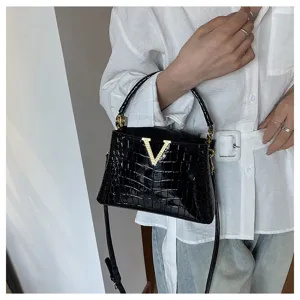 Chic black crocodile pattern handbag for women, elegant gold V clasp, versatile shoulder bag.