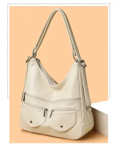Détail du sac à main souple en cuir PU avec multiples poches zippées et grande capacité utile.