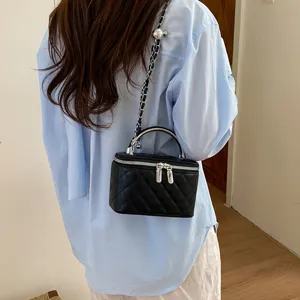 Black quilted chain crossbody bag for women, stylish small square shoulder handbag with top handle.