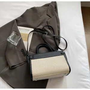 Color-block retro handbag detail showcasing premium fabric, dual handles, and sleek hardware.