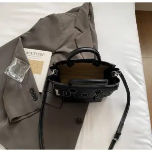 Black leather top handle tote bag with contrast stitching, versatile daily commuting shoulder bag.