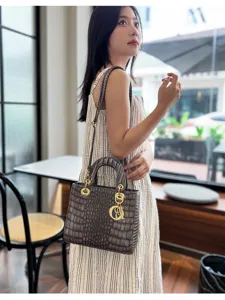 Detailed view of women crocodile pattern handbag, elegant shoulder bag in cafe scene.