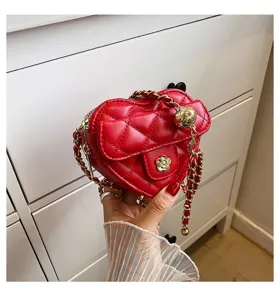 Rode gewatteerde hartvormige mini crossbody tas met gouden ketting en chique camelia.