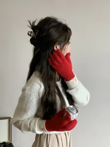 Knit gloves detailed shot featuring red and white color block design for winter warmth.