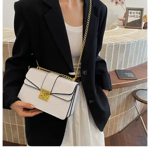 White crocodile pattern crossbody bag with gold chain strap and metal lock clasp for women.