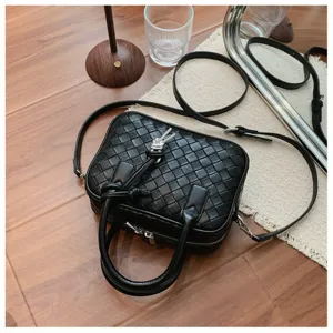 Stylish black woven crossbody bag for women, classic design camera handbag with top handles.