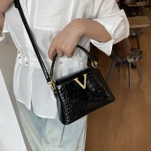 Black crocodile pattern crossbody bag for women, fashion luxury style shoulder handbag.
