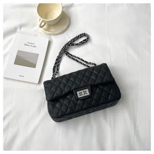 Black quilted chain shoulder bag detail, stylish women commuting crossbody bag with metal lock.