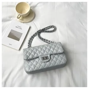 Close-up detail view of the luxury quilted chain shoulder bag with metallic lock closure.