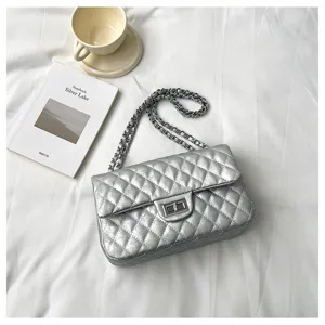 Silver quilted chain shoulder bag detail showing metallic lock and strap design.