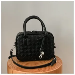 Black woven crossbody bag with top handles and knot detail, compact square daily fashion purse.