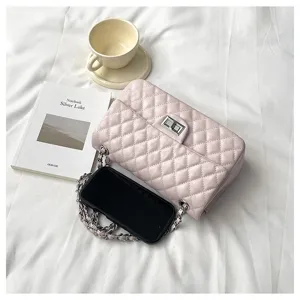 Detailed close-up of pink quilted chain shoulder bag with elegant metal lock on white background.