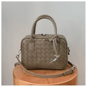 Detailed view of fashionable women woven leather shoulder crossbody casual small square bag